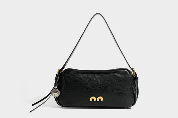 Compact black crinkled leather-look baguette shoulder bag with gold-tone arch hardware and adjustable strap, detail view 25