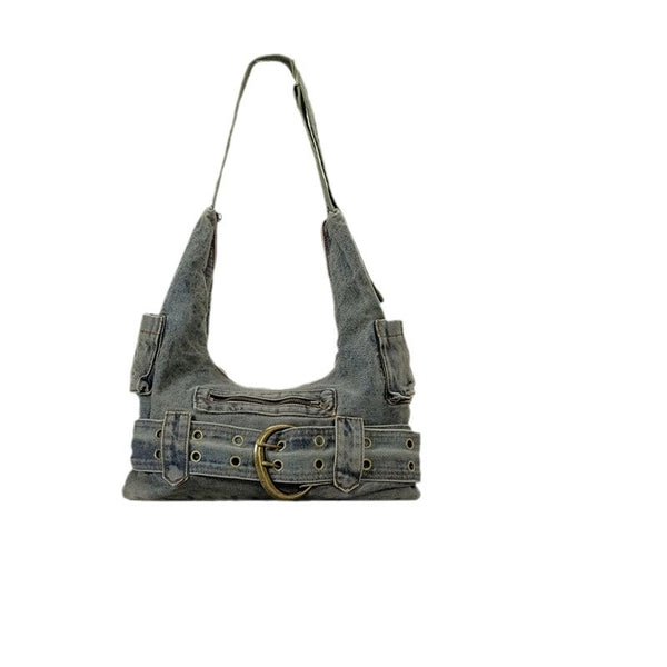 Washed blue-gray denim slouchy hobo shoulder bag with wide grommeted belt panel, brass-tone D-ring buckle, exterior zip