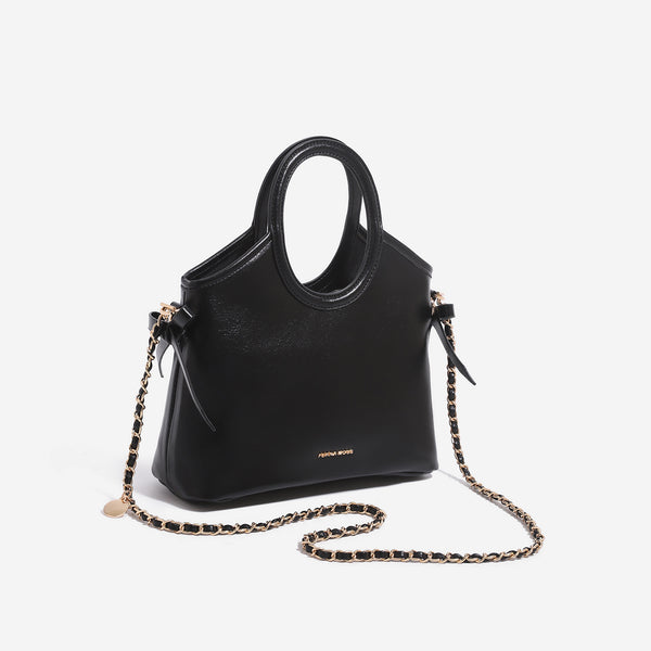 Structured trapezoid tote bag with oval top handle, glossy leather-look finish, side tie details, and gold-tone hardware