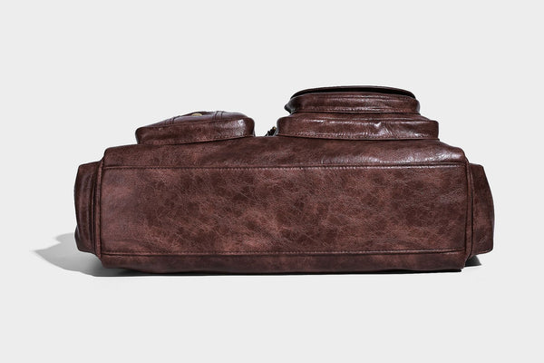 Distressed leather-look vintage satchel shoulder bag with multiple front zip pockets, dual top handles, and brass-tone