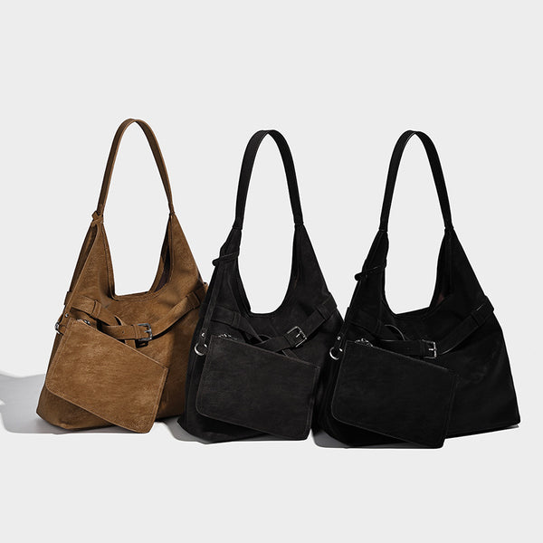 Slouchy oversized shoulder tote bag with matte textured finish, wrap-around buckle strap, and detachable front zip pouch