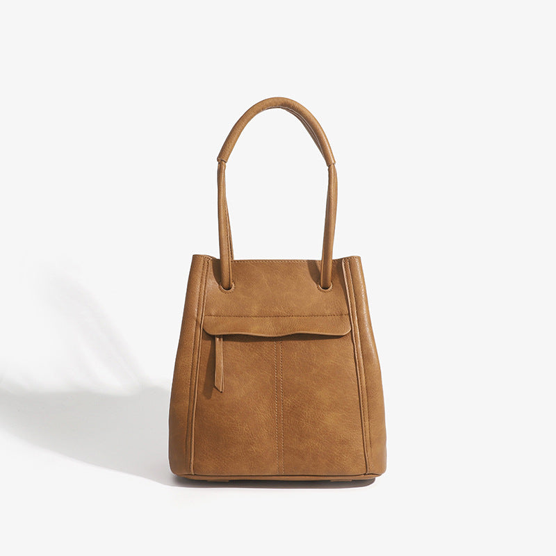 Retro structured matte leather-look tote bag in camel with front flap pocket, tassel pull, and double top handles, detail