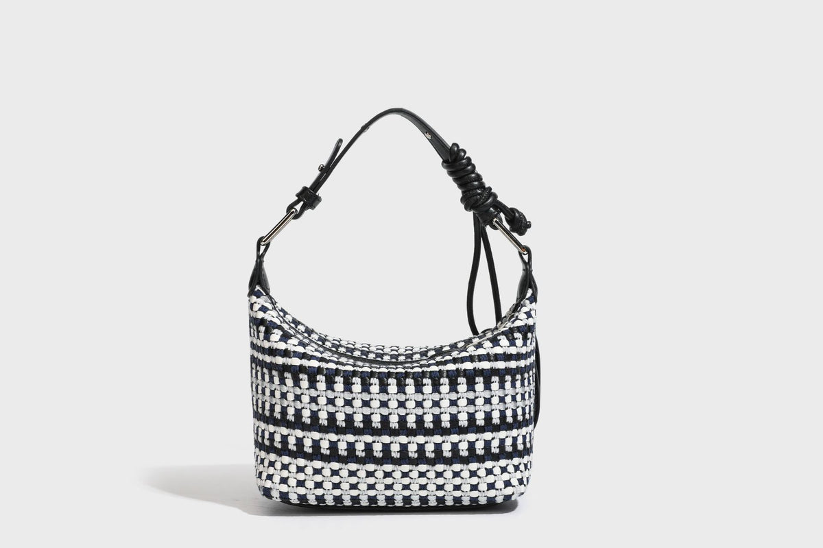 Small crescent shoulder bag in black-and-white woven textile with smooth black leather-look trim, zip-top closure, knotted