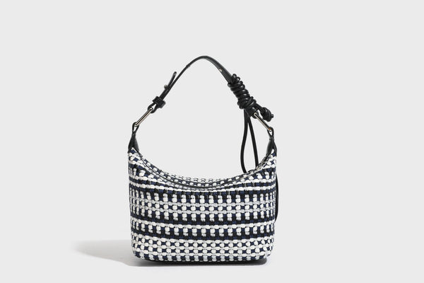 Small crescent shoulder bag in black-and-white woven textile with smooth black leather-look trim, zip-top closure, knotted
