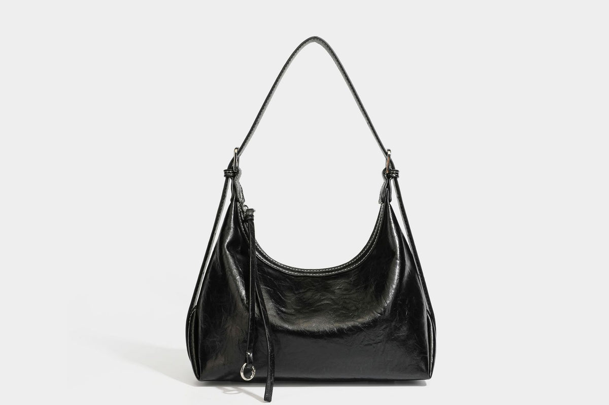 Slouchy hobo shoulder bag in glossy crinkled leather-look finish with zip-top closure and silver-tone ring hardware, detail