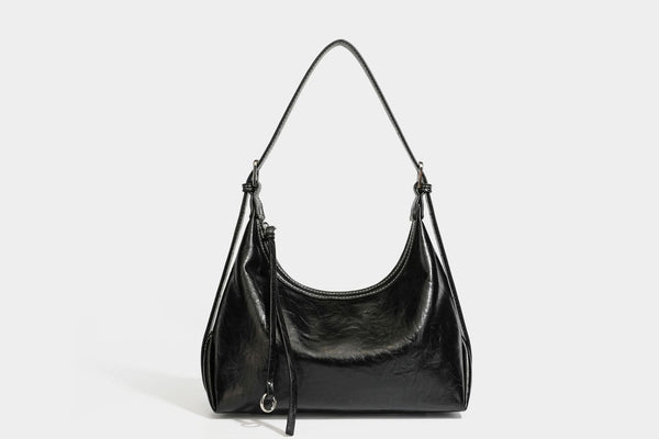 Slouchy hobo shoulder bag in glossy crinkled leather-look finish with zip-top closure and silver-tone ring hardware, detail