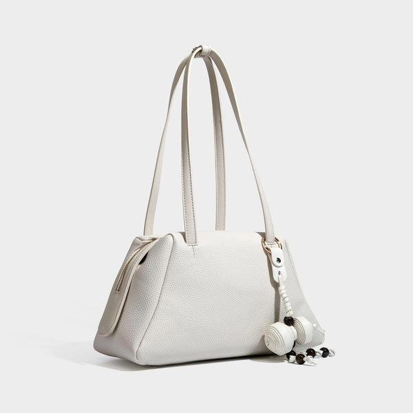 Structured trapezoid shoulder bag in dark brown pebbled leather-look finish with slim double straps, top zip closure, side