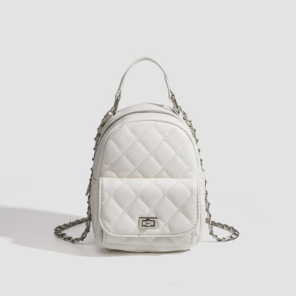 Compact diamond-quilted mini backpack handbag with silver-tone chain straps and turn-lock front pocket, front view