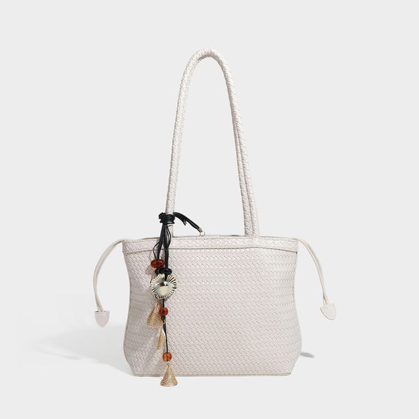 Structured woven leather-look tote bag in dark brown with long shoulder straps, side drawstring ties, and gold filigree