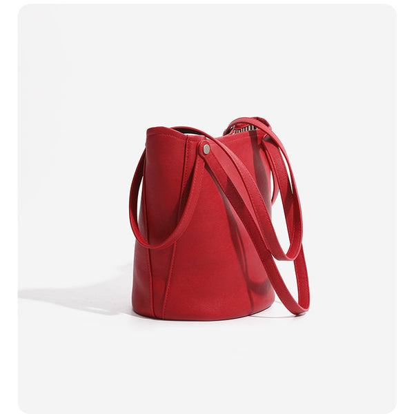 Large leather-look bucket tote bag with dual top handles and adjustable crossbody strap, detail view 18