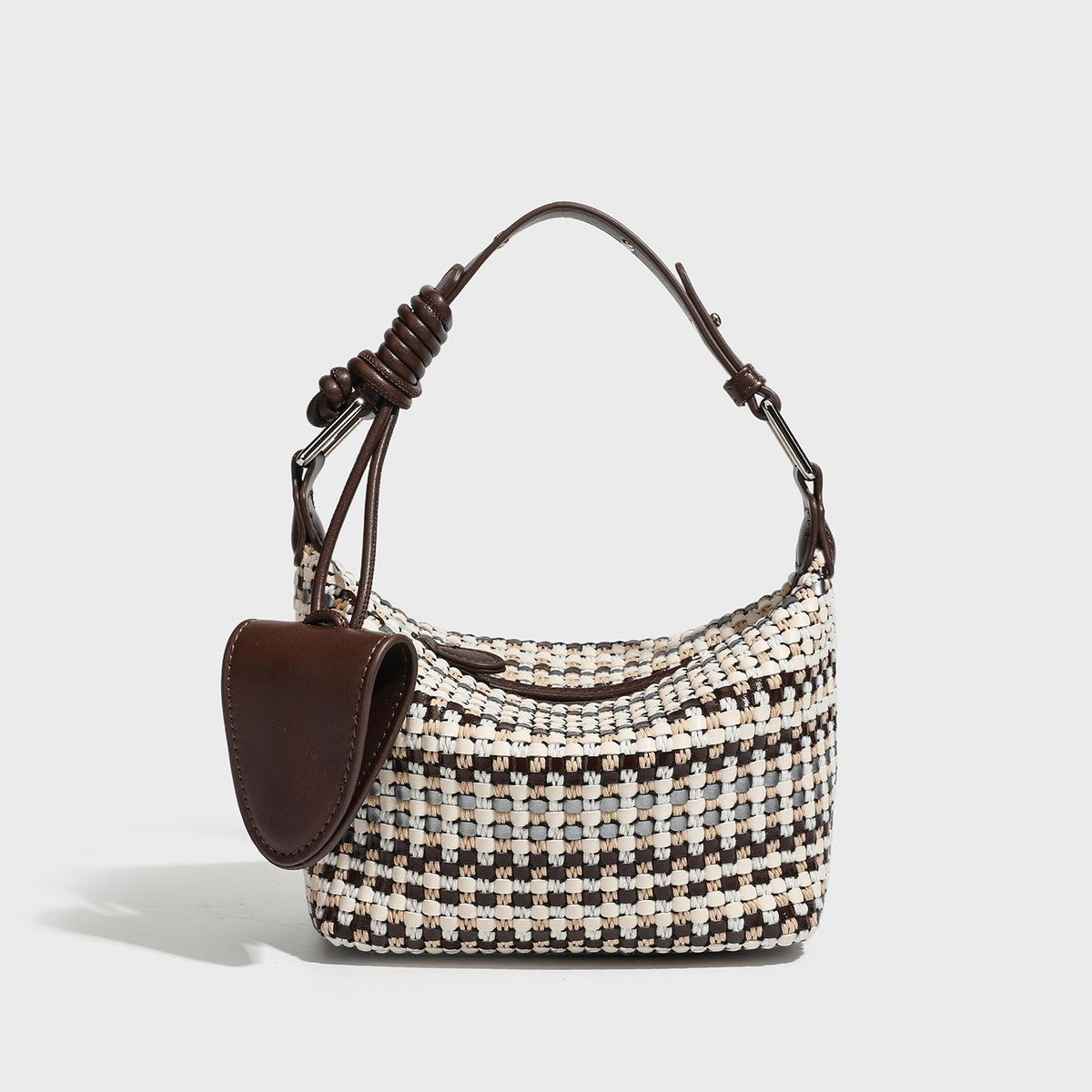 Small crescent shoulder bag in black-and-white woven textile with smooth black leather-look trim, zip-top closure, knotted