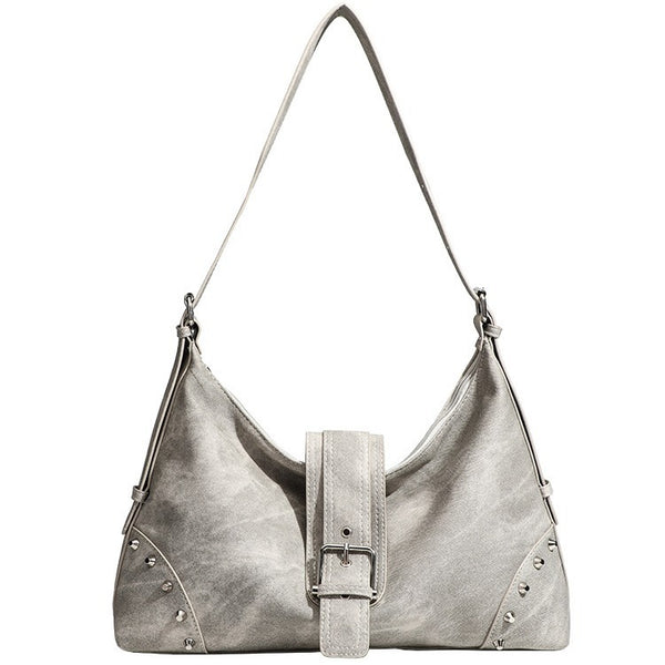 Slouchy trapezoid hobo shoulder bag with distressed textured finish, silver rivet corner accents, centre buckle strap, and