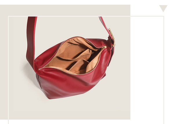 Large slouchy hobo shoulder bag in smooth leather-look finish with single long strap and gold-tone zip closure, detail view