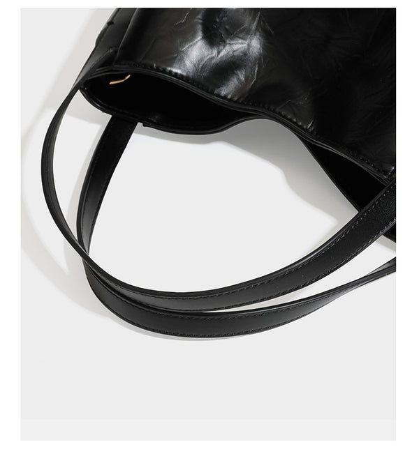 Black glossy crinkled leather-look convertible shoulder tote bag with gold gourd-shaped emblem hardware and detachable