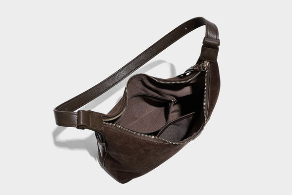 Dark brown suede-look hobo shoulder bag with top zip closure, adjustable strap, and small detachable mini pouch, detail view