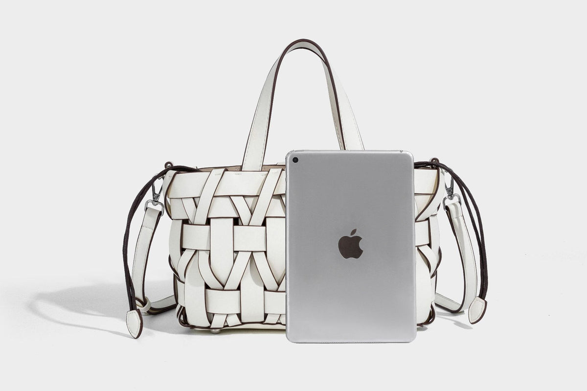Structured woven basket tote handbag with contrasting dark trim, double top handles, detachable shoulder strap, and