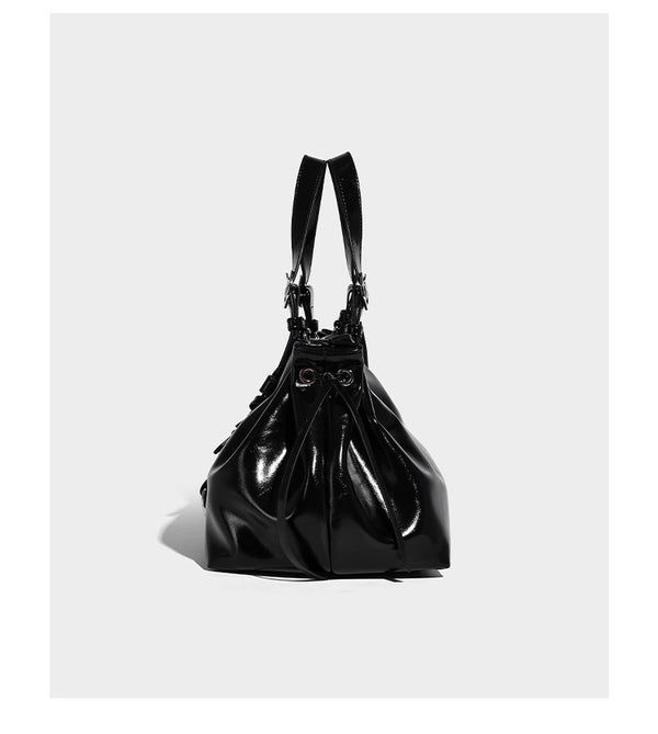 Glossy patent-look slouchy tote bag with ruched drawstring sides, dual top handles, silver ring hardware, and detachable