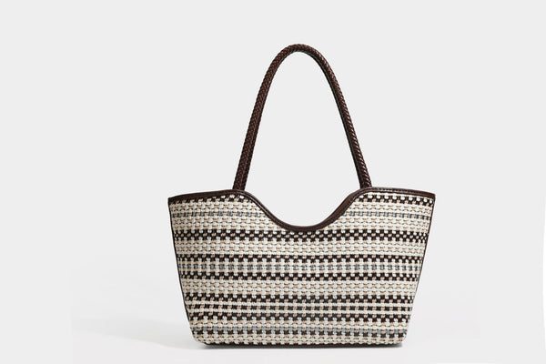 Large woven checker-pattern tote bag with dark braided shoulder straps, leather-look trim, and drawstring side ties, detail