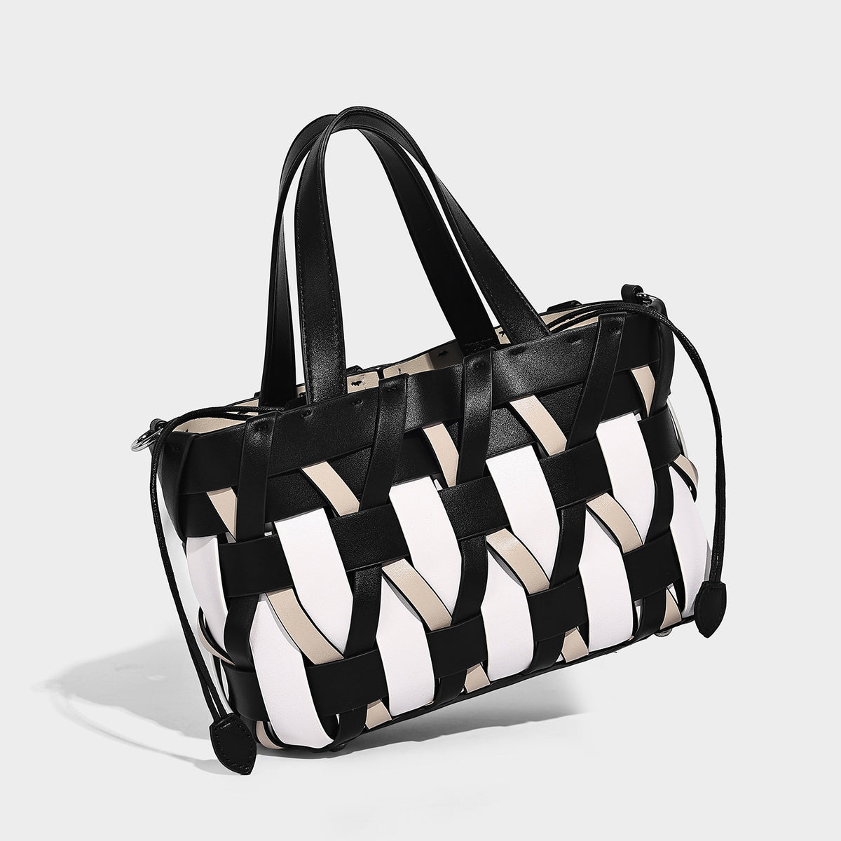 Small structured woven lattice tote bag with dual top handles and detachable shoulder strap in brown and cream leather-look
