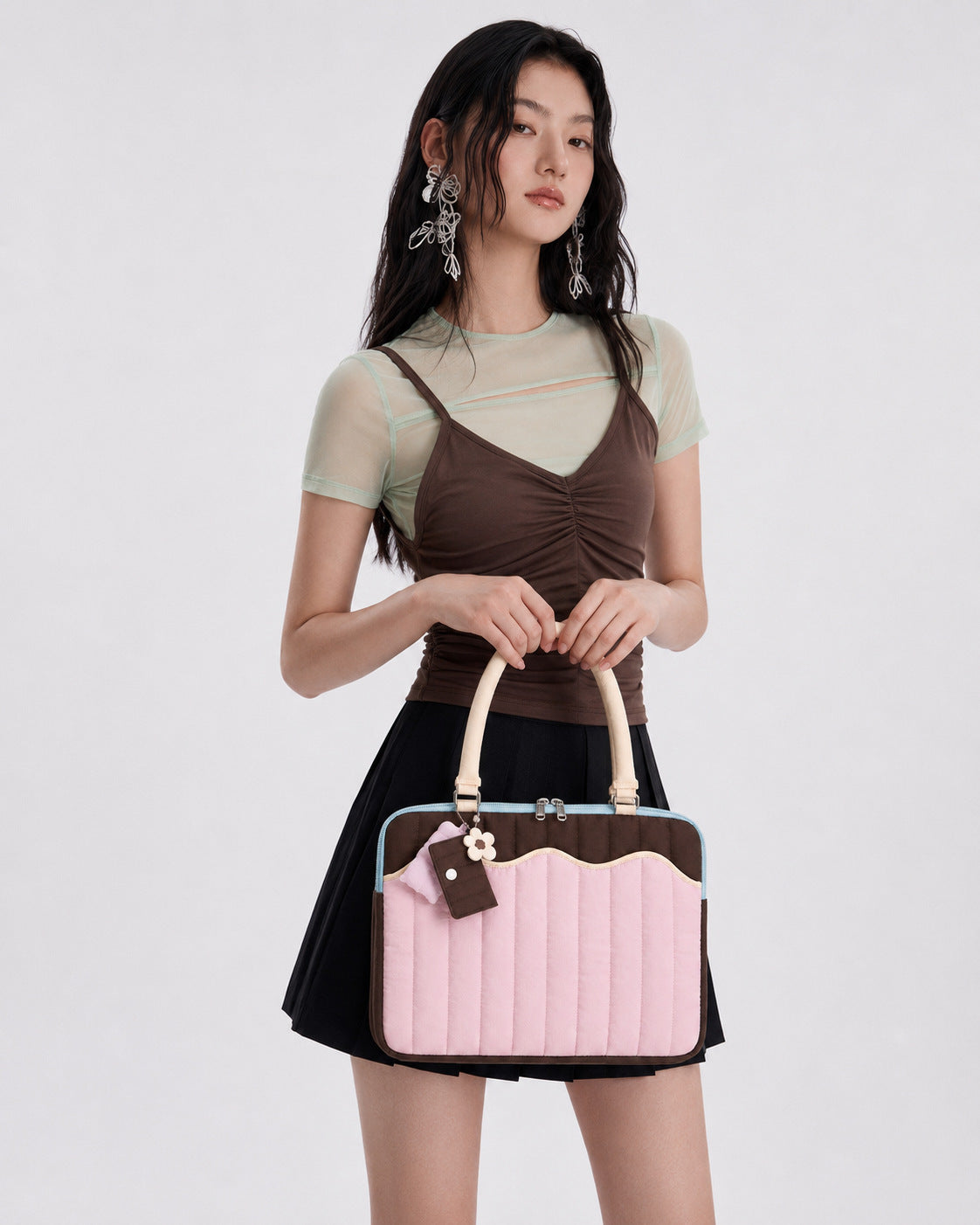 Quilted colorblock handbag with wavy scalloped front panel, padded arched top handles, and dual zip closure, detail view 11