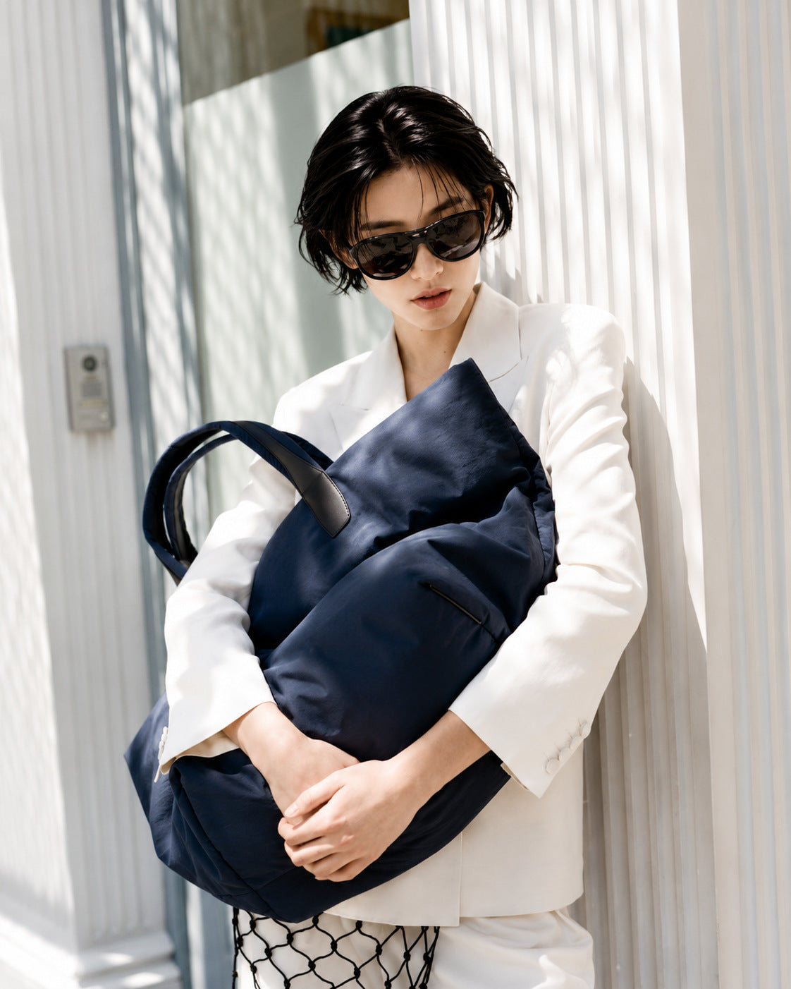 Large lightweight nylon tote bag with zipper closure, black leather-look handles, and trapezoid silhouette, detail view 15