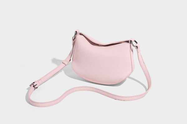 Small crescent half-moon bag in pebbled leather-look finish with braided top handle, silver-tone ring hardware, and, detail