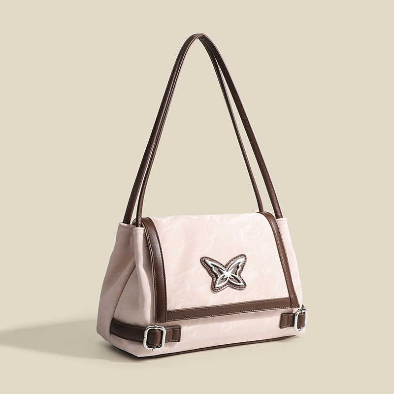 Structured crinkle-finish flap shoulder bag with butterfly metal appliqué and dark brown contrast trim, detail view 3