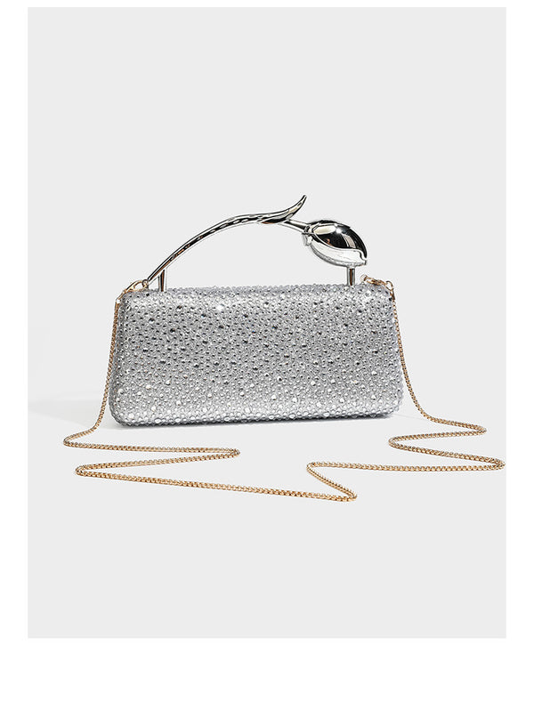 rectangular hard-case rhinestone evening clutch with sculptural gold-tone branch-and-bud top handle and detachable chain
