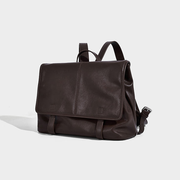 Structured tan leather-look flap backpack handbag with top handle, silver buckle hardware, and fold-over front closure