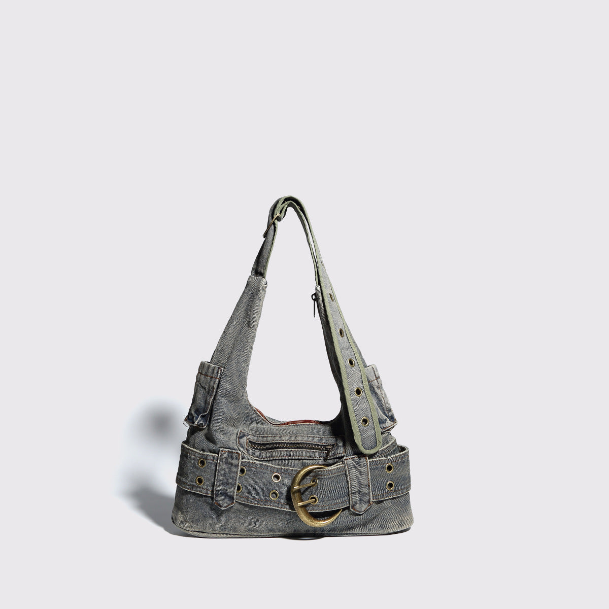 Washed faded denim hobo shoulder bag with wide brass-tone buckle belt panel, eyelet detailing, front zip pocket, and dual