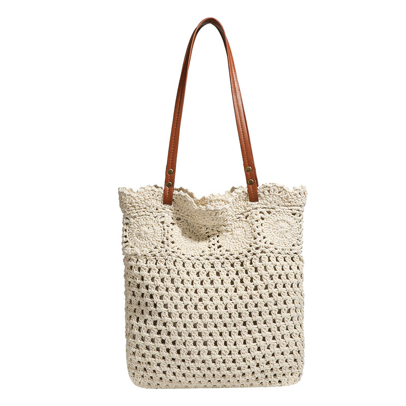 Woven crochet shoulder tote bag with scalloped floral top edge, tan leather-look straps, and antique gold rivets, detail view