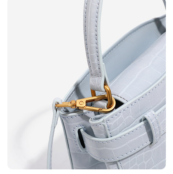 Small structured crocodile-embossed top-handle bag with gold-tone turn-lock closure and detachable shoulder strap, detail
