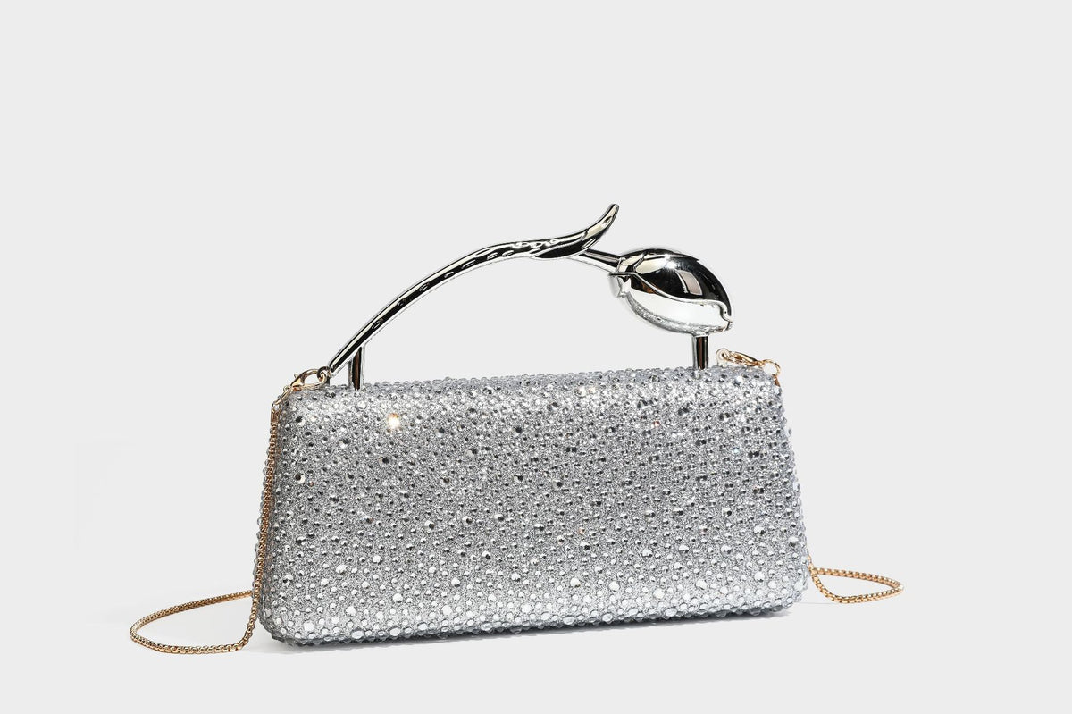 rectangular hard-case rhinestone evening clutch with sculptural gold-tone branch-and-bud top handle and detachable chain