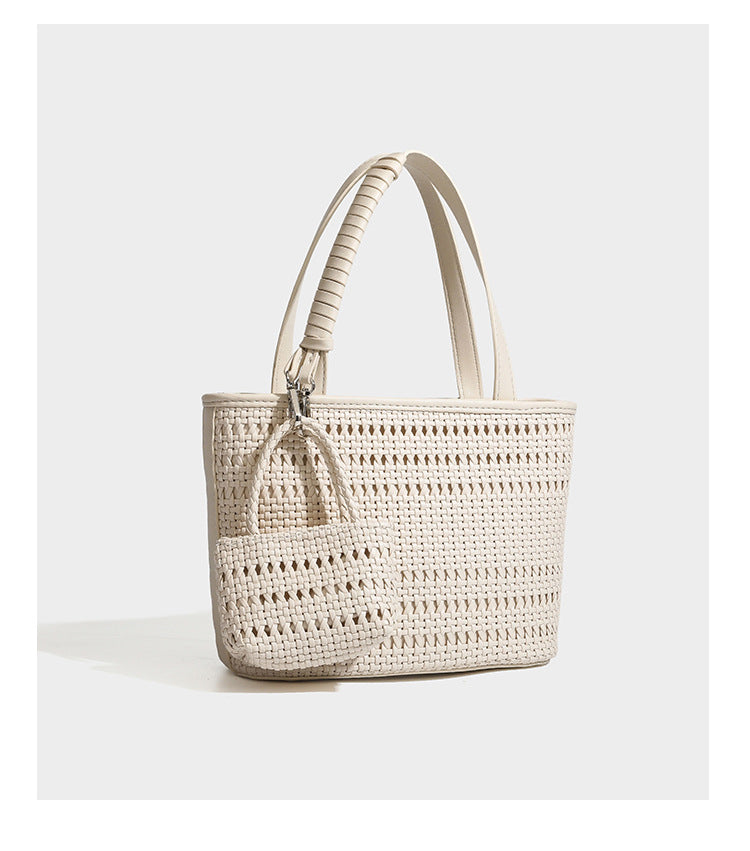 Structured open-weave tote bag with smooth leather-look trim, double top handles, detachable crossbody strap, and mini zip