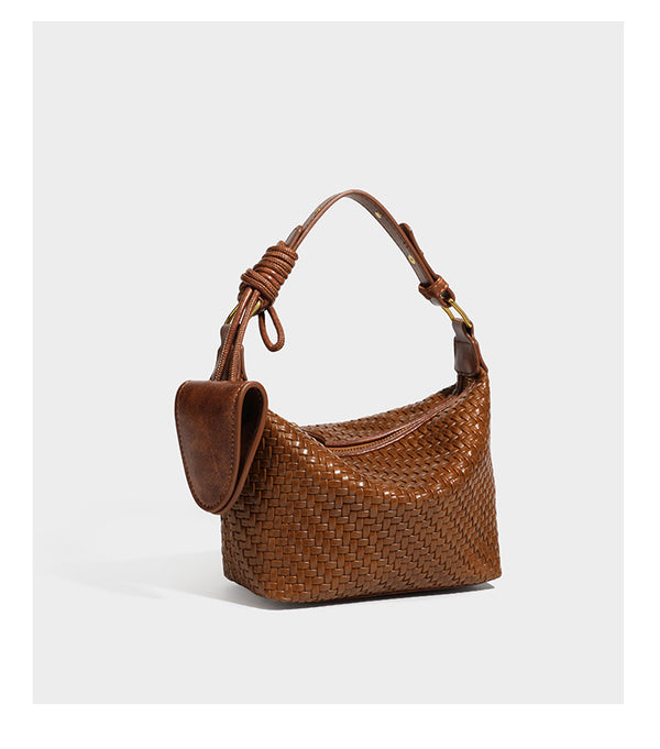 Small glossy basket-weave hobo shoulder bag in brown with knotted top handle, flap accent pocket, and gold-tone hardware