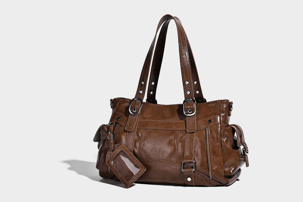 Glossy structured black tote shoulder bag with silver buckle hardware, zip pockets, dual top handles, and detachable, detail