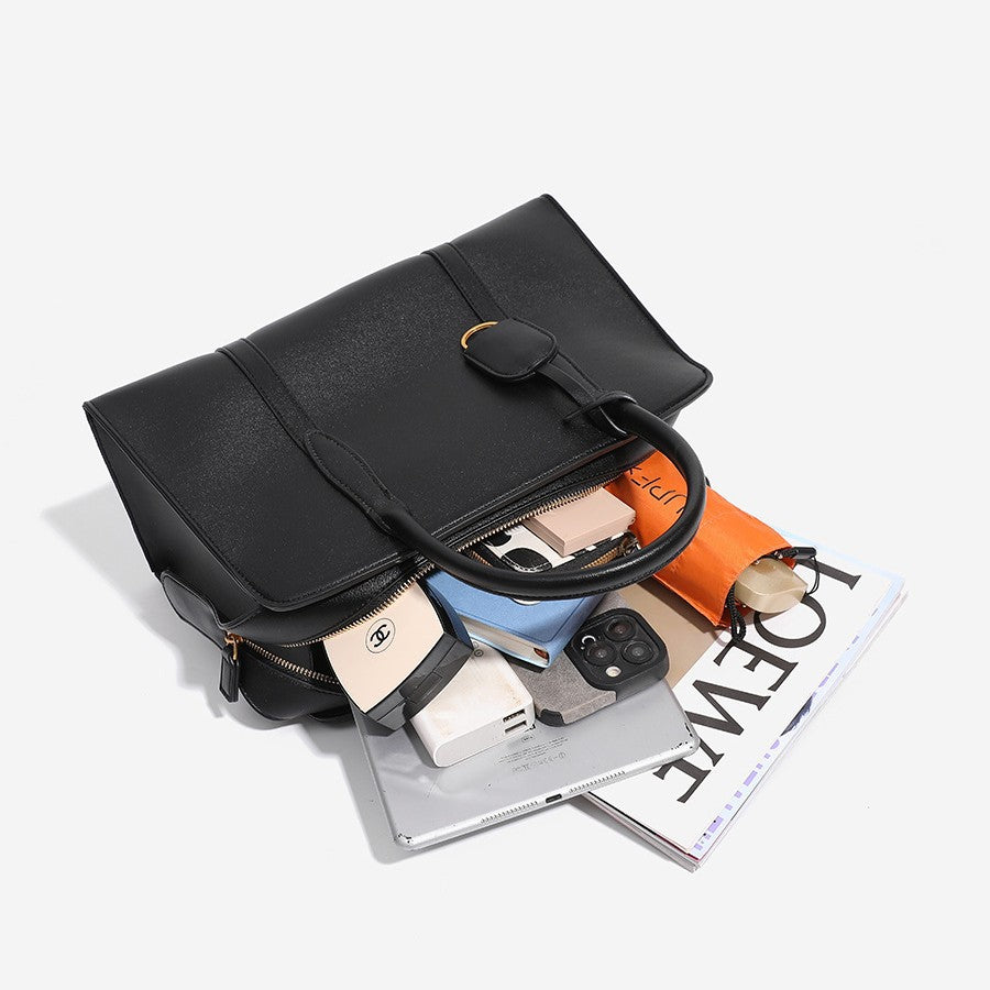 Structured trapezoid Boston satchel bag with dual top handles, gold-tone lock charm, and top zip closure, detail view 4