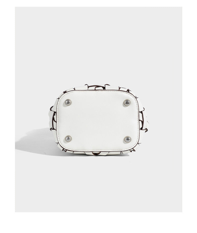 Small woven leather-look bucket bag with interlaced strip exterior, drawstring closure, and adjustable crossbody strap