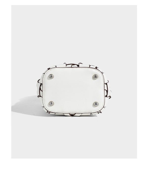 Small woven leather-look bucket bag with interlaced strip exterior, drawstring closure, and adjustable crossbody strap