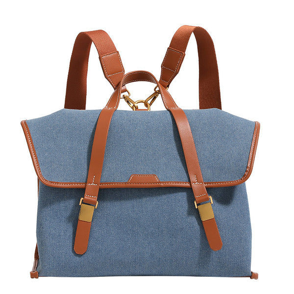 Strukturierter wandelbarer Rucksack im Denim-Look mit Besatz in Cognac-Lederoptik, goldfarbenen Schnallen und Tragegriff an der Oberseite