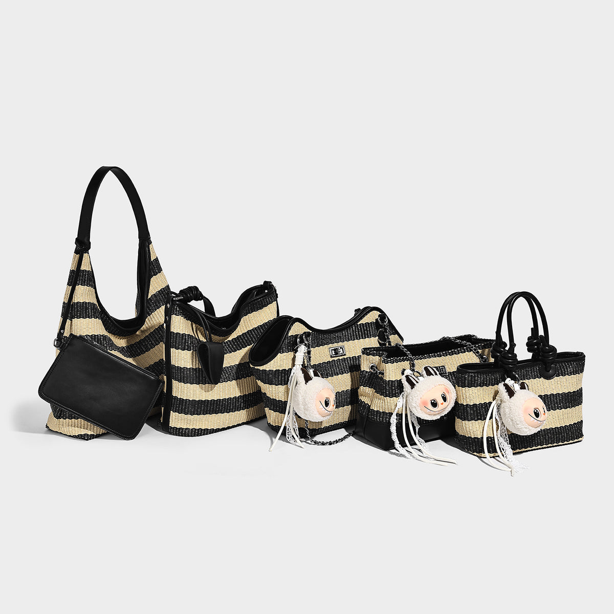 Black and beige striped woven shoulder tote bag with leather-look trim and detachable black zip pouch, detail view 2