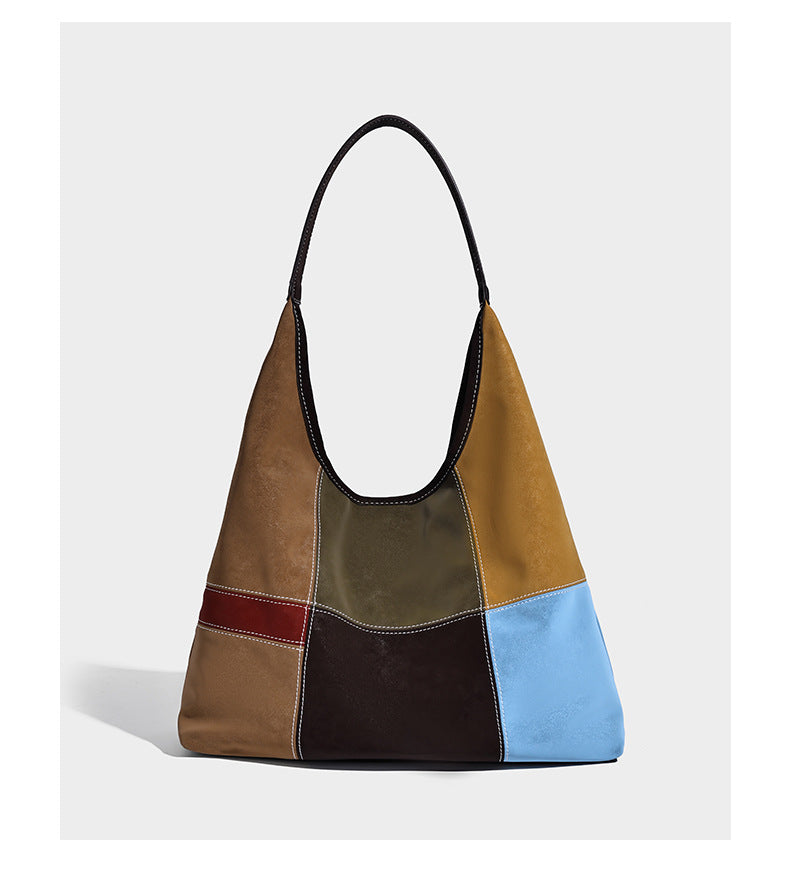 Multicolor patchwork hobo shoulder bag with brown tan olive mustard red and blue suede-look panels, contrast white stitching