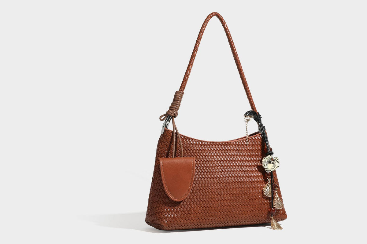 Woven-texture hobo shoulder bag in brown with braided top handle, adjustable crossbody strap, front flap pocket, and, detail
