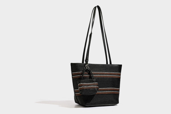 Large structured woven tote bag with striped basket-weave finish, long shoulder straps, and detachable mini pouch charm