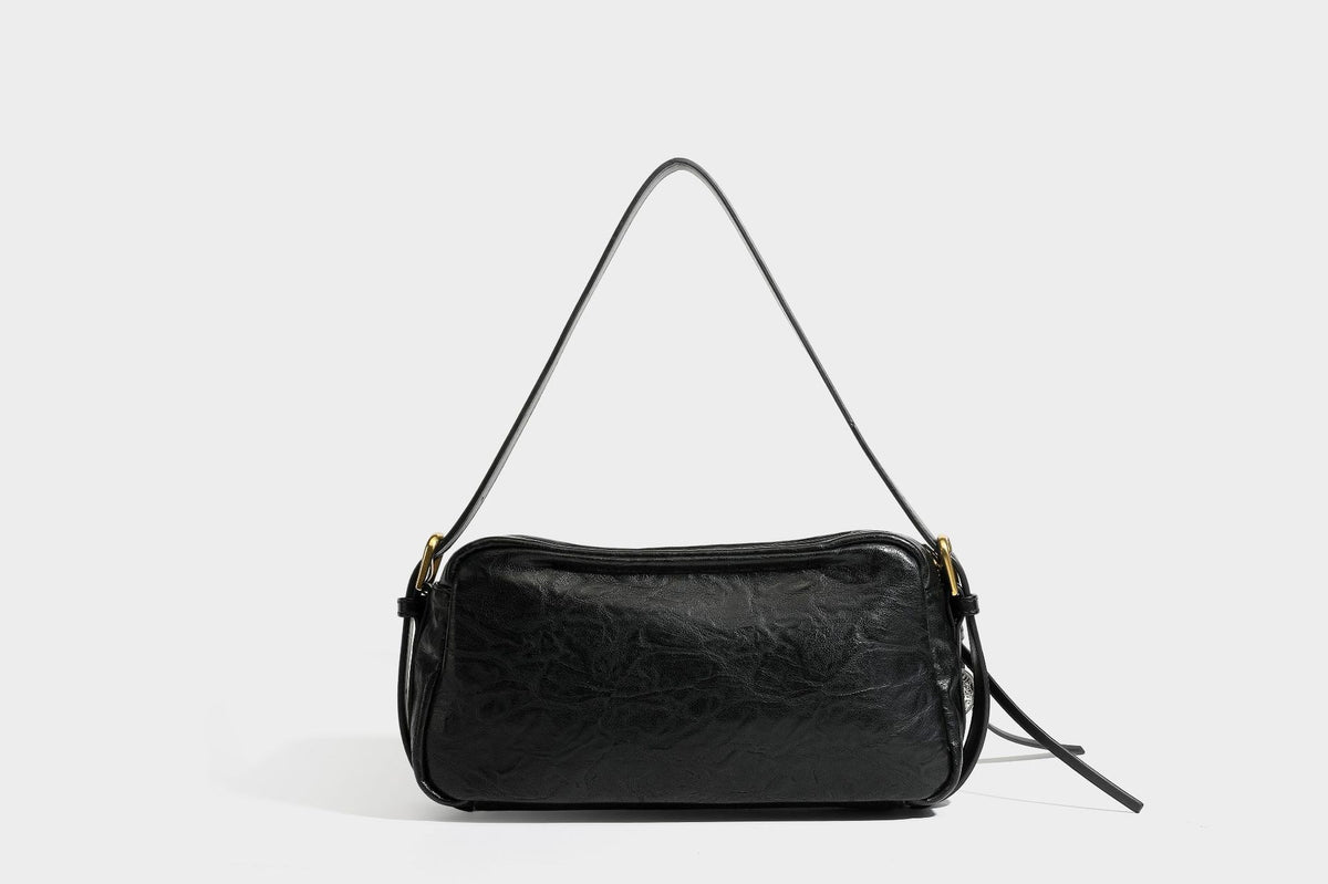 Compact black crinkled leather-look baguette shoulder bag with gold-tone arch hardware and adjustable strap, detail view 28