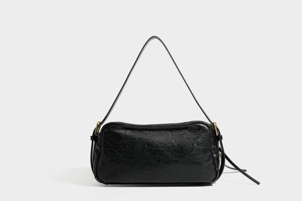 Compact black crinkled leather-look baguette shoulder bag with gold-tone arch hardware and adjustable strap, detail view 28
