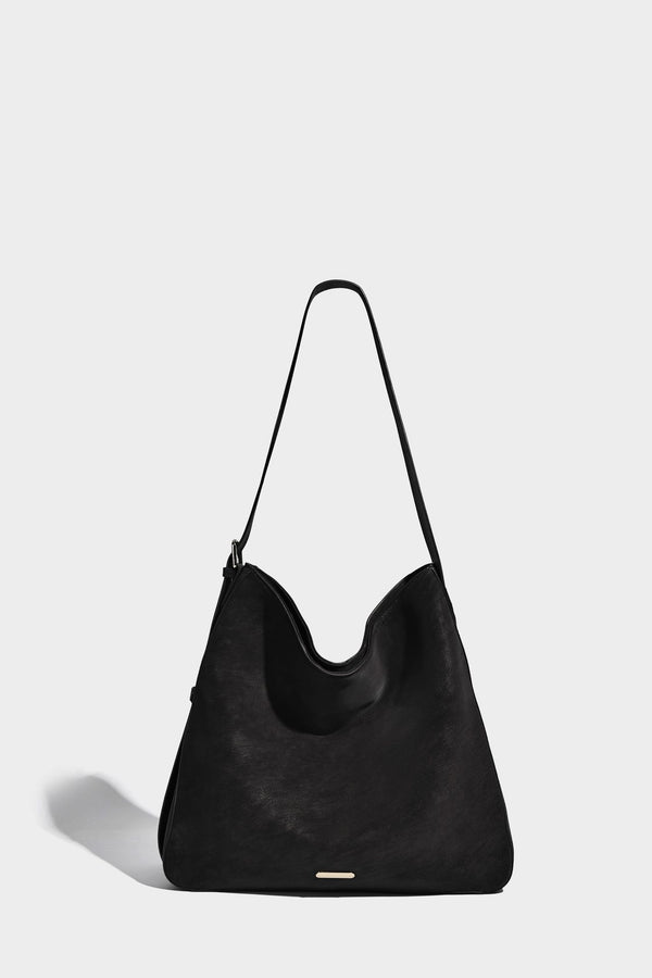 Large slouchy hobo shoulder bag in matte leather-look finish with adjustable strap and gold-tone bar hardware, detail view 18