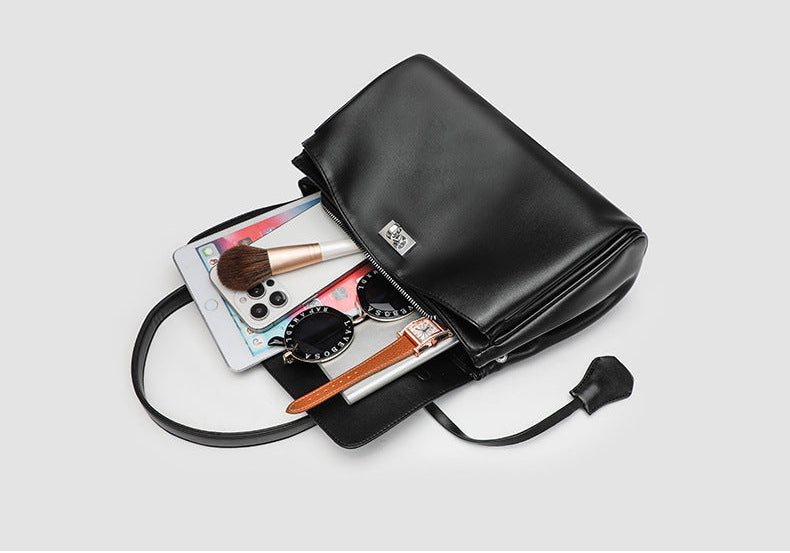 Structured black leather-look flap satchel bag with silver turn-lock hardware and top handle, detail view 12