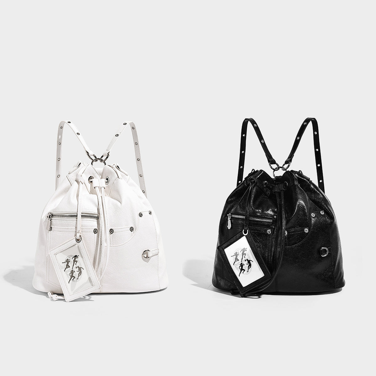 Glossy black convertible bucket backpack with silver grommet-studded straps, drawstring cinch closure, and front zip pocket