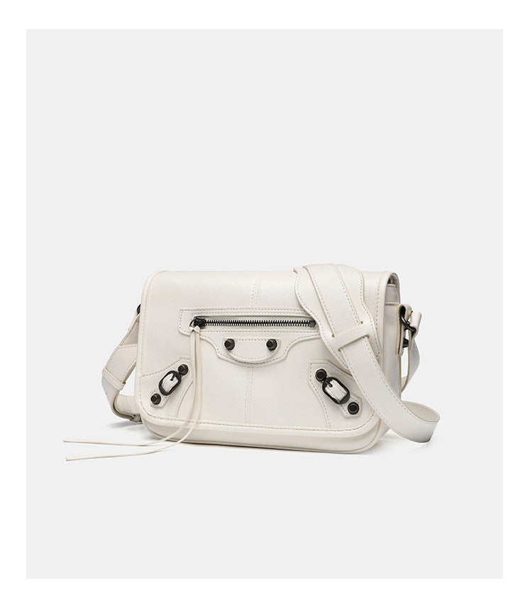 Small structured rectangular crossbody bag with crinkle leather-look finish, front zip pocket, gunmetal stud hardware, and